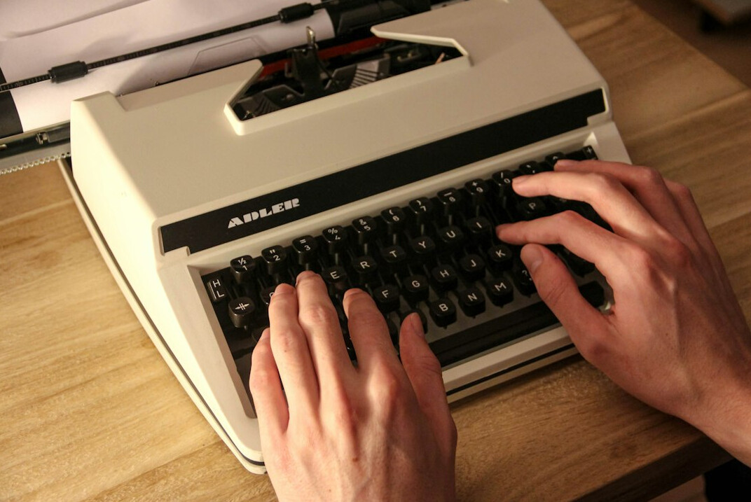 writer typing on old typewriter